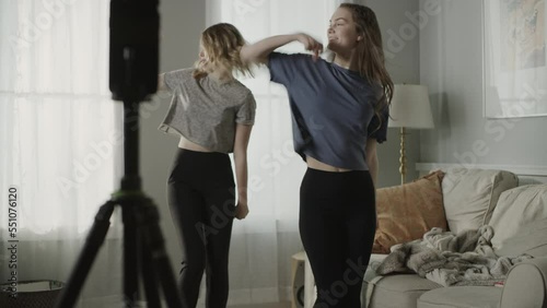 Tilt up to girls recording dance routine on cell phone for social media / Cedar Hills, Utah, United States