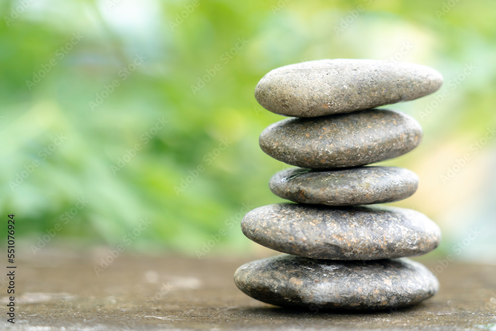 Meditation stones with rain drop water on cement floor on green nature background. Pyramid pebbles free space. Calm, buddhism symbol or aromatherapy set concept. Meditation stones with rain drop water on cement floor on green nature background. Pyramid pebbles free space. Calm, buddhism symbol or aromatherapy set concept.