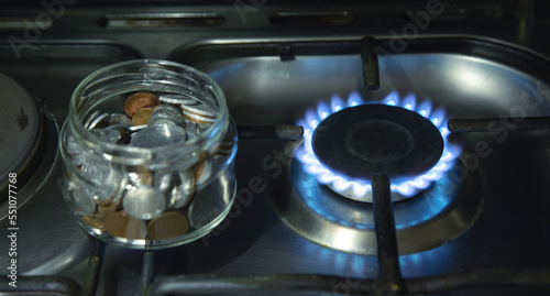 Burning gas stove and coins. Gas price