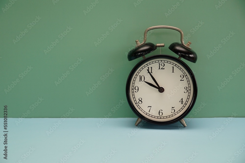 alarm clock against gren background alarm clock against gren background
