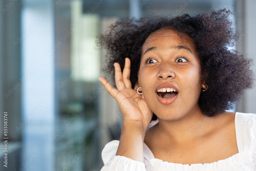 Fototapeta premium Surprised African woman hearing or listening to bad news