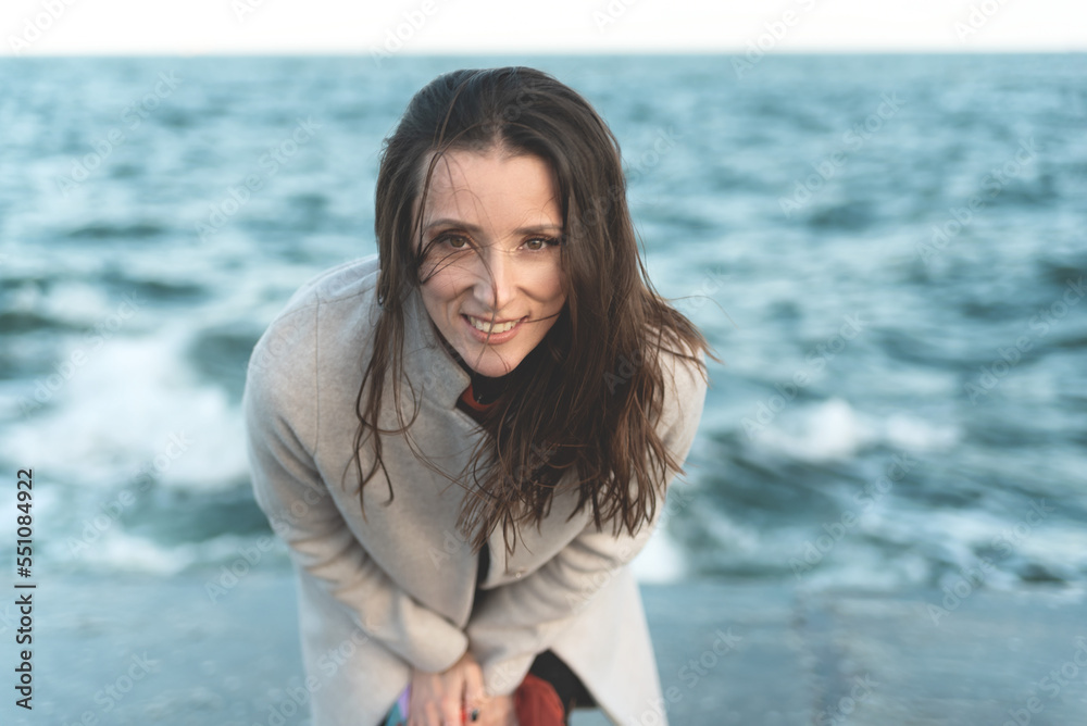 portrait of a tender and sensitive woman on the background of the sea. Hair development in the wind portrait of a tender and sensitive woman on the background of the sea. Hair development in the wind