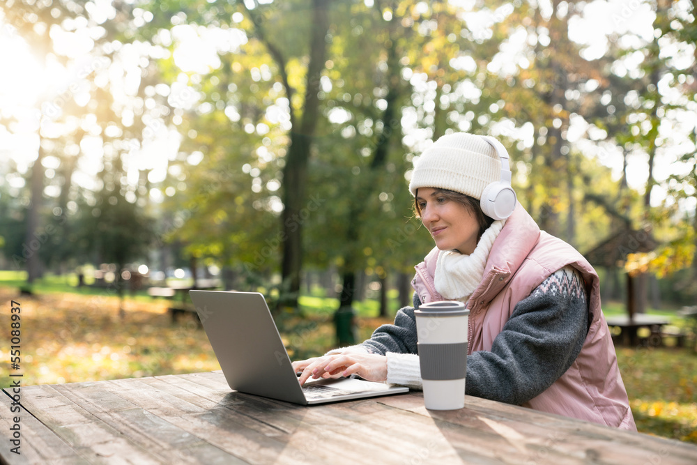 Woman in the park with a laptop. Woman in the park with a laptop.