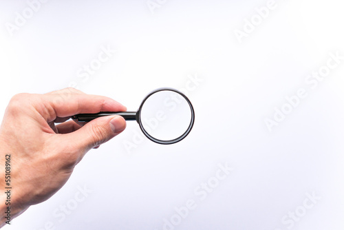 Magnifying glass in hand on white background, concept of search