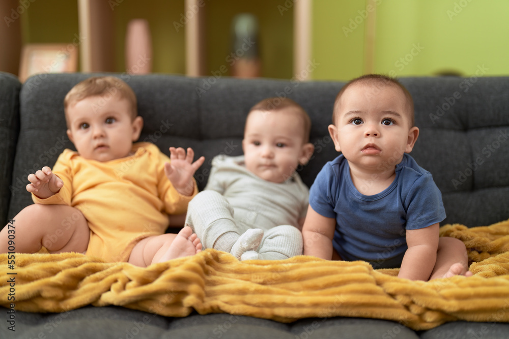 Group of toddlers sitting on sofa at home Group of toddlers sitting on sofa at home