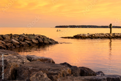 motorboat with jetties at sunset