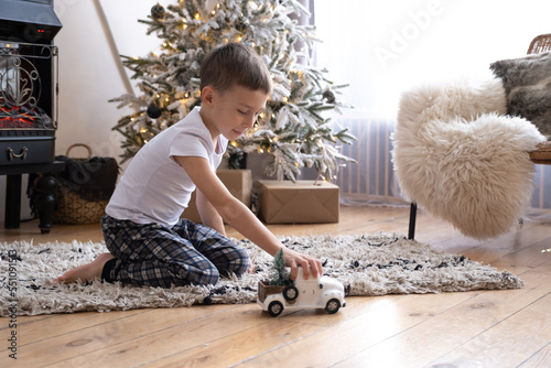 boy playing with a toy car on christmas eve