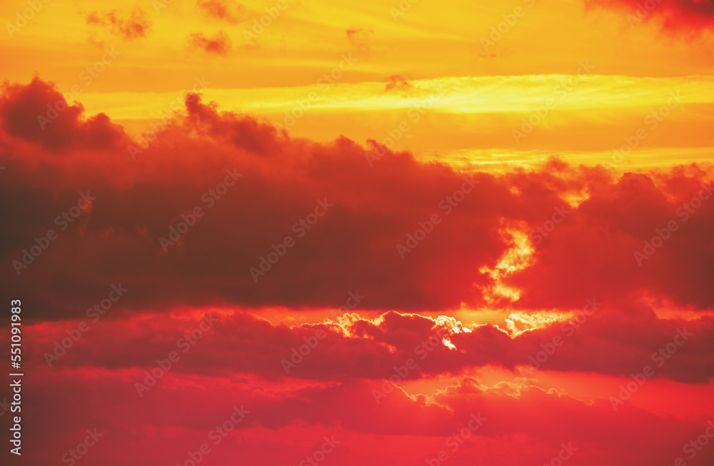 Dramatic cloudy sky at sunset. Orange red gradient color. Sky texture, abstract nature background