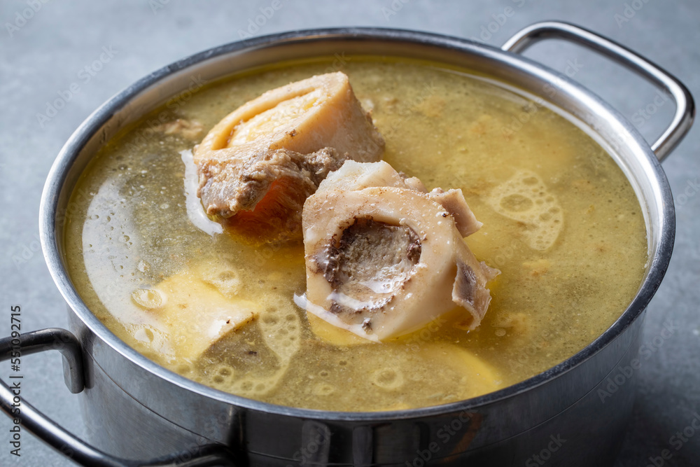 Boiled bone and broth. Homemade beef bone broth is cooked in a pot on. Bones contain collagen, which provides the body with amino acids, which are the building blocks of proteins. Boiled bone and broth. Homemade beef bone broth is cooked in a pot on. Bones contain collagen, which provides the body with amino acids, which are the building blocks of proteins.