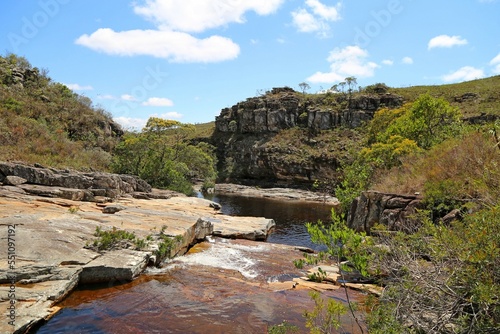 Creek flowing over rocks in small canyon with vegetation and rocks. Region of Conceiçao de Mato Dentro in Minas Gerais, Brazil