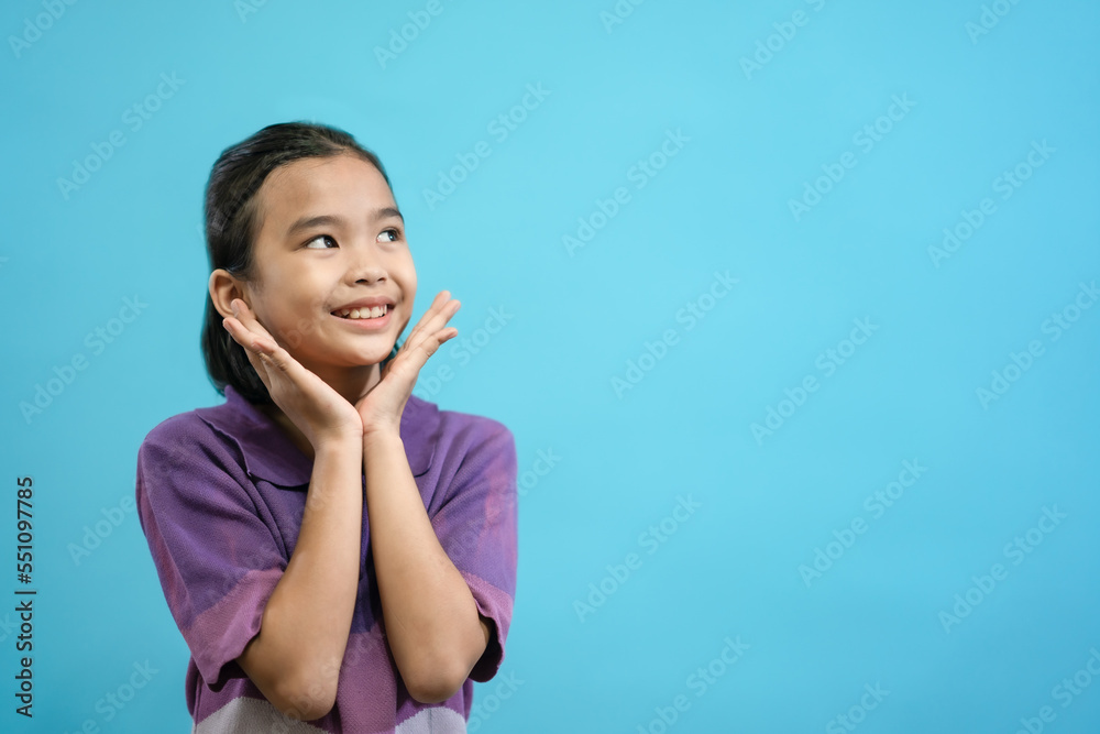 Children close up photo of cute and cheerful people, looking and smile on blue pastel background Children close up photo of cute and cheerful people, looking and smile on blue pastel background