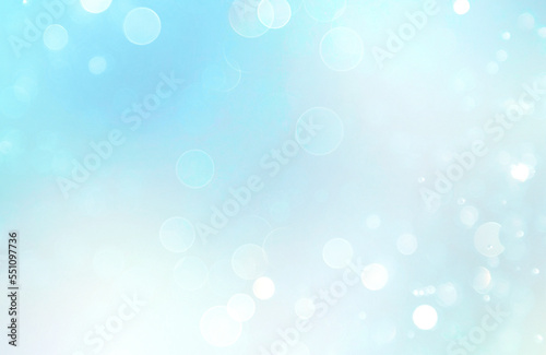 Light blue glowing winter background, christmas bokeh, abstract blurred texture.