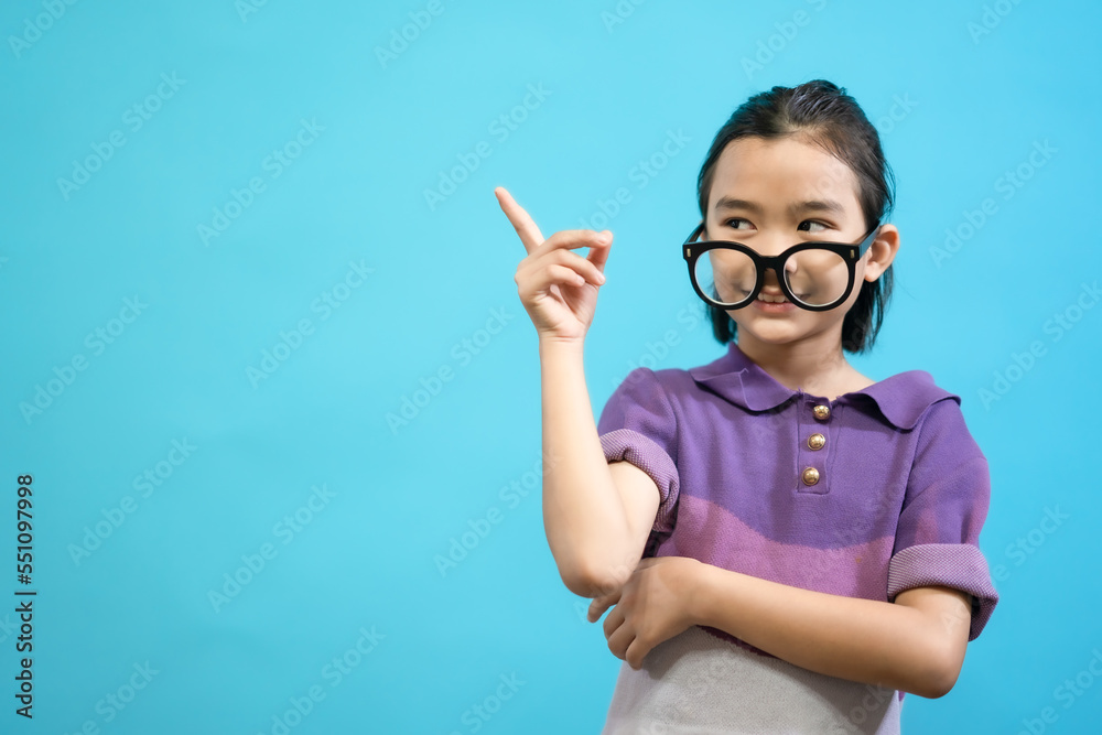 Children close up photo of cute and cheerful people, wearing glasses looking and smile on blue pastel background