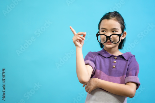 Children close up photo of cute and cheerful people  wearing glasses looking and smile on blue pastel background
