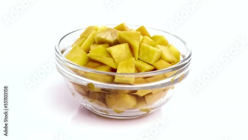 sliced mango in a bowl isolated on white background