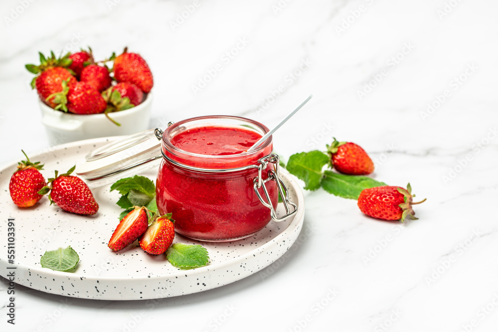 Jar of strawberry jam and fresh berries on wooden board white background. Long banner format