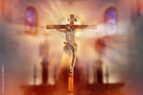 Foto crucifix, jesus on the cross in church with ray of light from stained glass