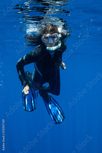 woman snorkeling in polynesian deep waters