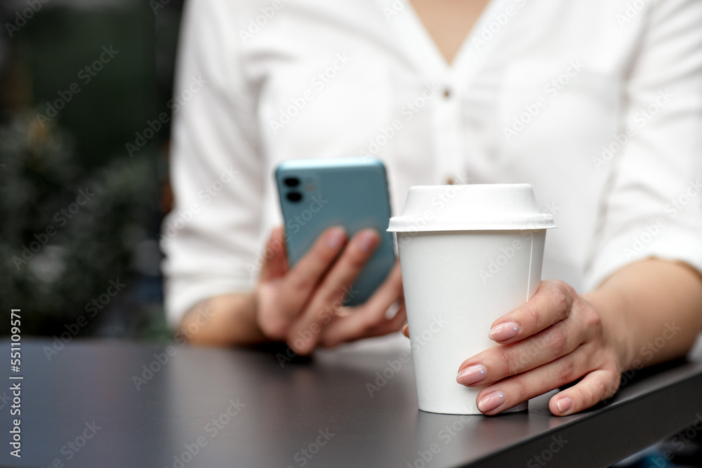 Female hand holding a Coffee paper cup outdoor Female hand holding a Coffee paper cup outdoor