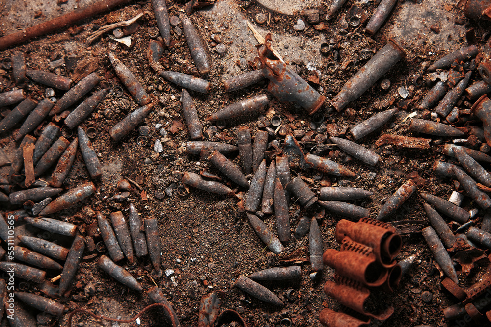 Burnt ammunition, bullets and casings after the fire. Burned arsenal of weapons, fire in the armory. Military theme background. militaristic wallpaper, the backside of guns Burnt ammunition, bullets and casings after the fire. Burned arsenal of weapons, fire in the armory. Military theme background. militaristic wallpaper, the backside of guns