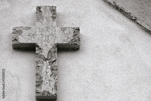 Black and white Christian cross in stone with space for text.  Christian symbol, religious faith symbolism