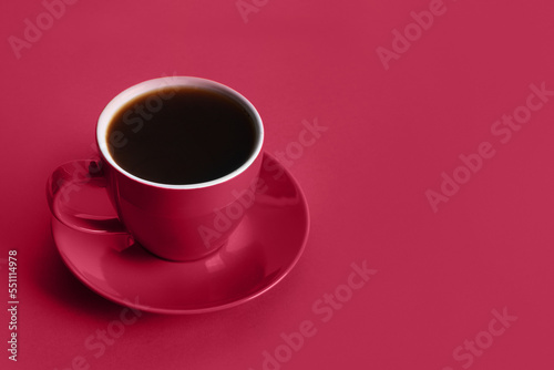 Cup of black coffee on viva magenta background. Space for text. Trending color of 2023 - Viva Magenta.