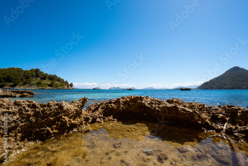 view of the sea and ships - rocky coast