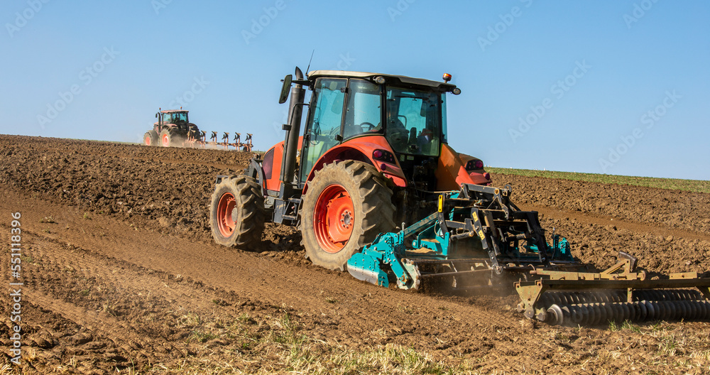 Tracteur labourant les champs au printemps dans la campagne. Tracteur labourant les champs au printemps dans la campagne.