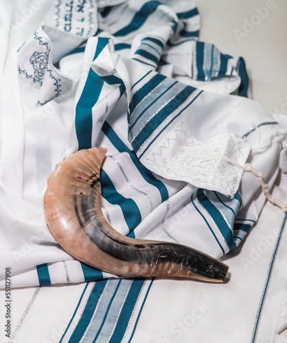 Canvas Print Shofar, the animal horn blown on Yom Kippur, lies on a blue and white tallit