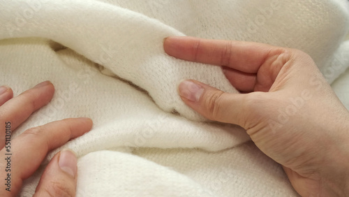 Cuadro en lienzo female's hand on the fabric of white plush cloth with soft nap