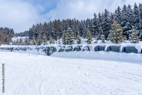 Magicagic carpet ski lift in a glass tunel. Snowy winter day in the french ski resort. High quality photo