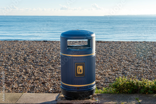 Blue trah can on the seafront at Southsea, Hampshire, UK. Waste collection. photo