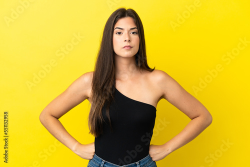 Young Brazilian woman isolated on yellow background angry