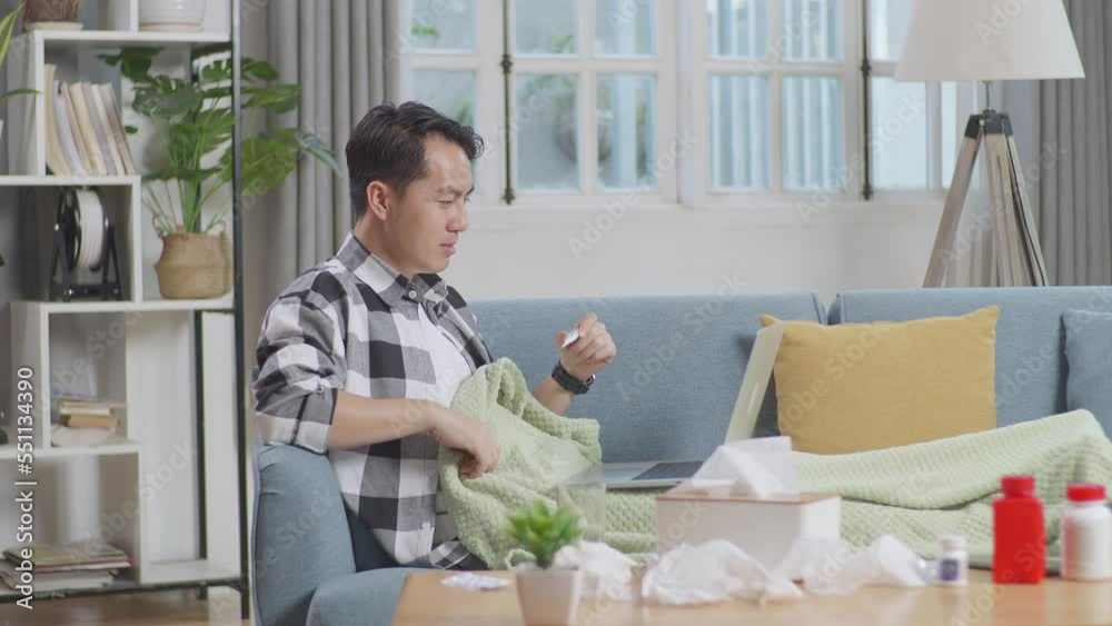 Sick Asian Man With Blanket Holding A Thermometer To The Video Call With Doctor On A Laptop While Lying On Sofa In The Living Room At Home
Sick Asian Man With Blanket Holding A Thermometer To The Video Call With Doctor On A Laptop While Lying On Sofa In The Living Room At Home