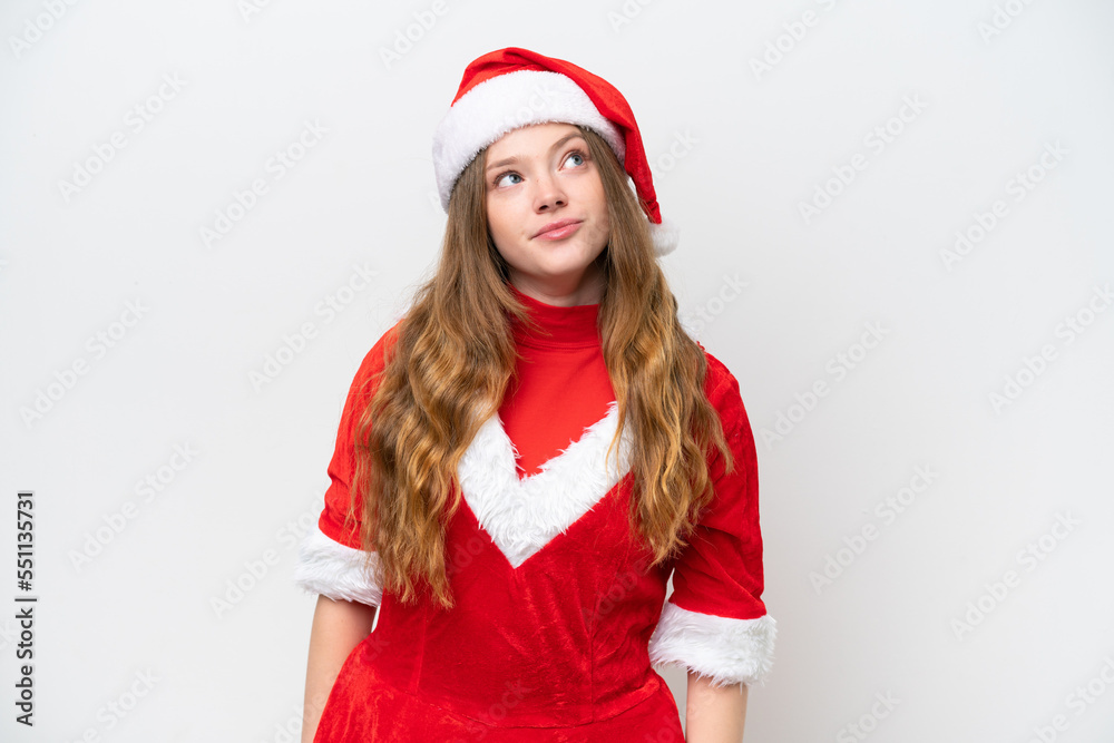 Young caucasian woman with Christmas dress isolated on white background and looking up Young caucasian woman with Christmas dress isolated on white background and looking up