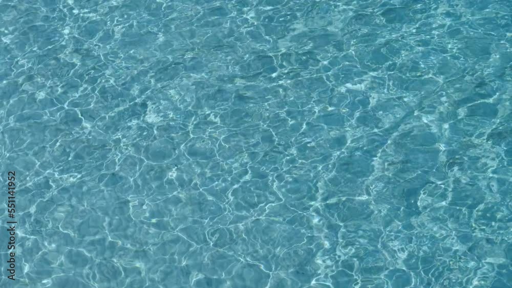 Abstract shapes of shallow blue clear sea water ripples on white fine beach sand