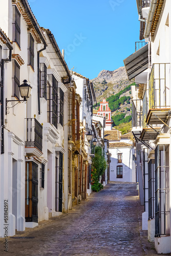 Picturesque alley of white houses at the foot of the mountain in the old town of Grazalema  Cadiz  Spain.