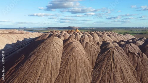 Industrial salt mining. Aerial view of a quarry for the extraction of minerals. Mountains of products for the production of potash salt. Extraction of potash fertilizers photo