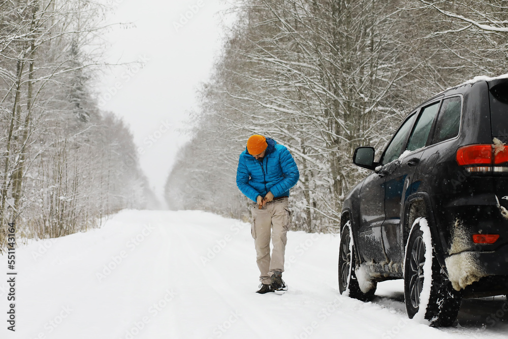 Hiking winter landscape. A man with a backpack travels in winter. A man in a snowy field. Hiking winter landscape. A man with a backpack travels in winter. A man in a snowy field.