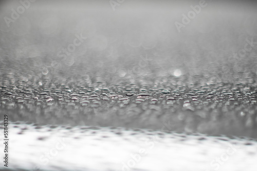 water drops on a glossy surface with bokeh light effects © geoki