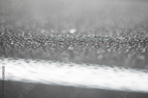 water drops on metal surface with bokeh bubbles and shallow depth of field