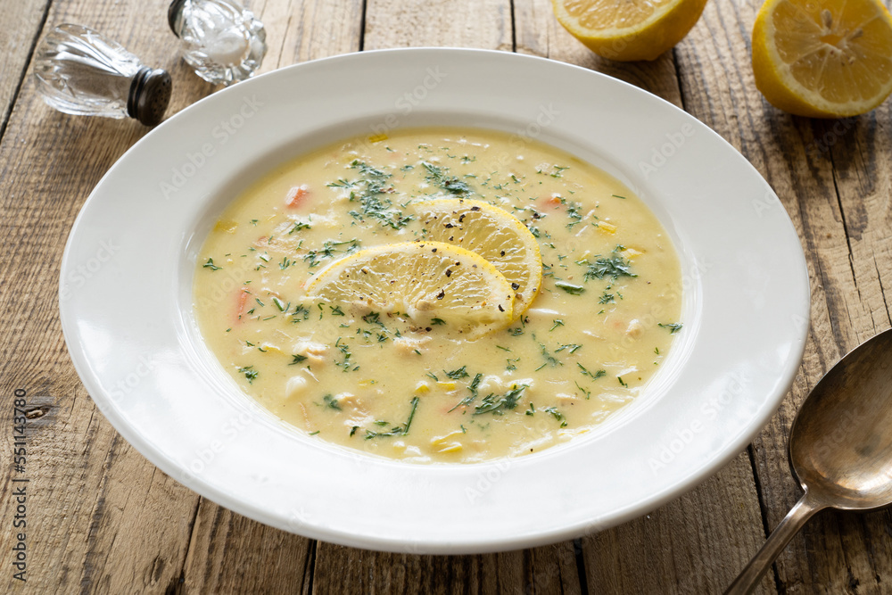 Lemon creamy soup on wooden table
