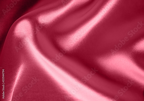 A sample of the New Fashion color Viva Magenta. Texture of natural silk fabric with folds. The image is colored in Viva Magenta Color of the Year 2023.