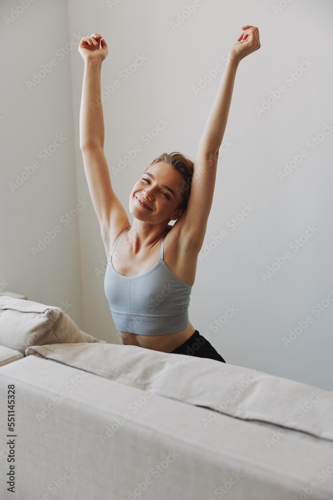 Happy woman smile lying at home on the couch relaxing on a weekend at home with a short haircut hair without filters on a white background, free copy space Happy woman smile lying at home on the couch relaxing on a weekend at home with a short haircut hair without filters on a white background, free copy space