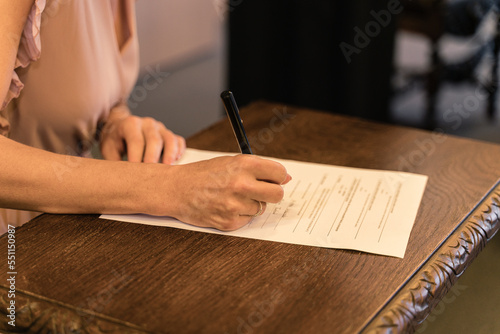 Signing documents for a witness during a civil wedding at a state office. Civil marriage ceremony at the registry office.