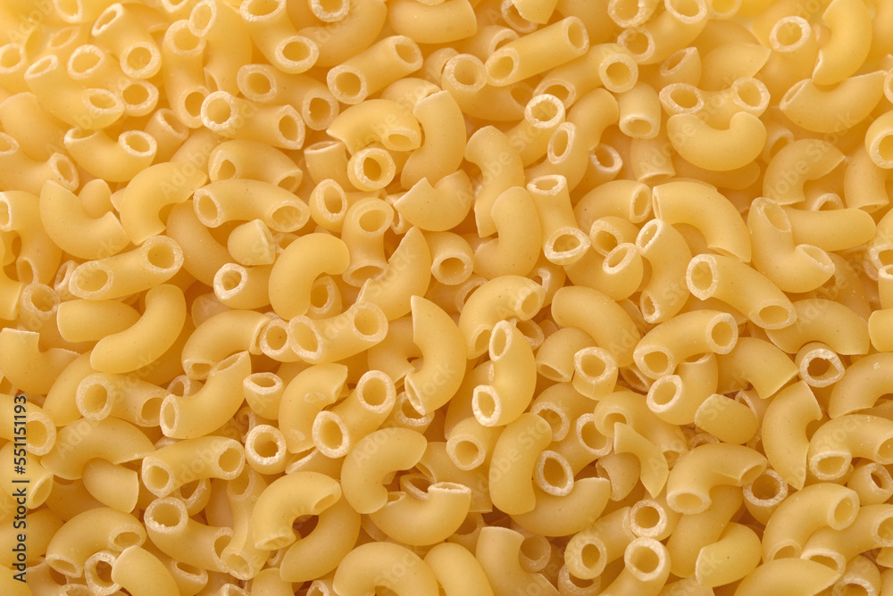 Raw uncooked pasta horns background Raw uncooked pasta horns background