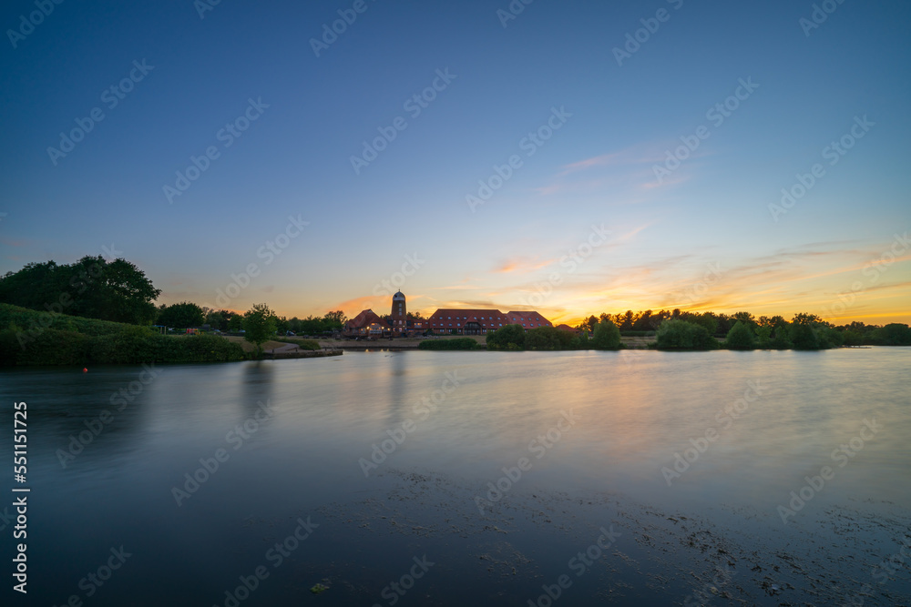 Caldecotte lake old windmill at sunset