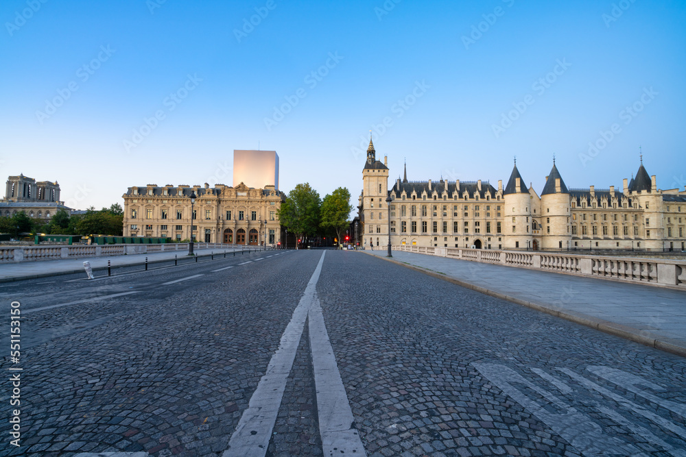 Exchange bridge and The Conciergerie palace and prison by the Seine river at dawn in Paris. France