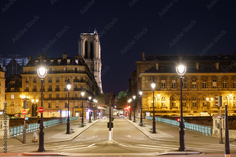 Pont d'Arcole overlooking Notre Dame cathedral at night in Paris. France