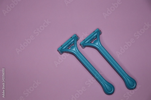 blue Gilette razors on a pink background